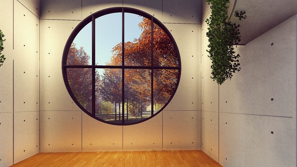 A Room With A Round Black Window Frame