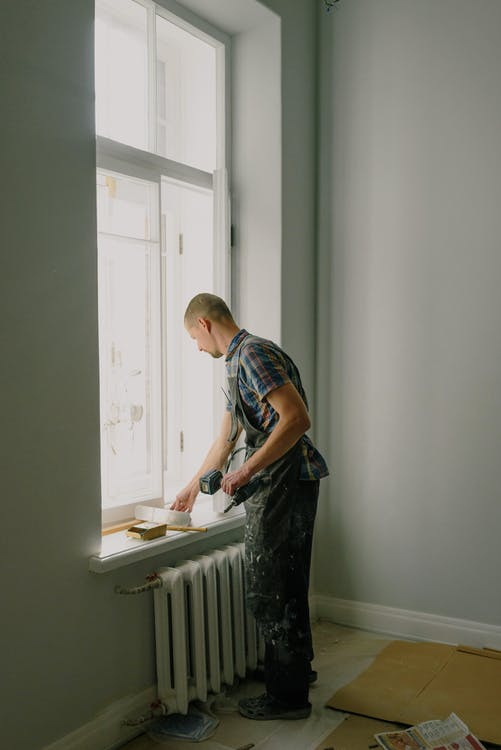 A repairman repairing windows