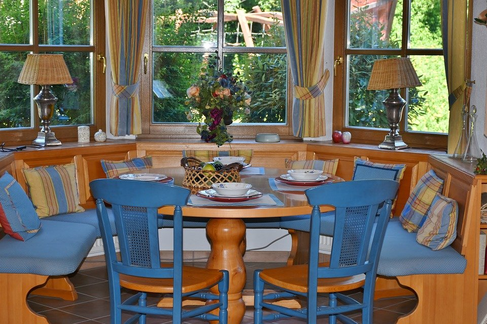 A dining room with bow windows and patio door