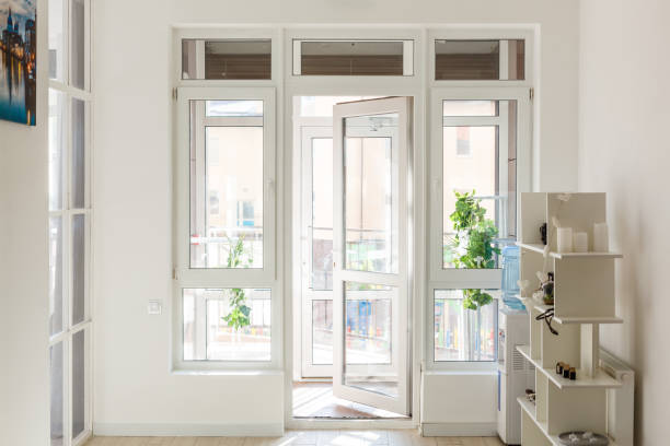 An open glass door with a white frame