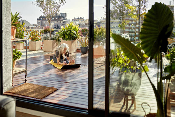 A woman exercising on her patio that opens with a sliding door 