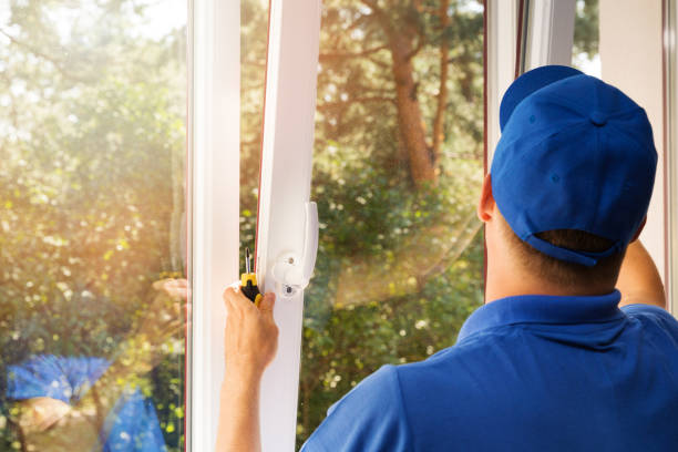 A professional handyman replacing the window glass in a home