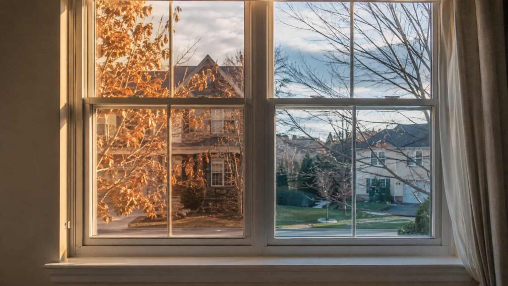 Residential window exposed to partial sunlight and shade during a DMV seasonal temperature change